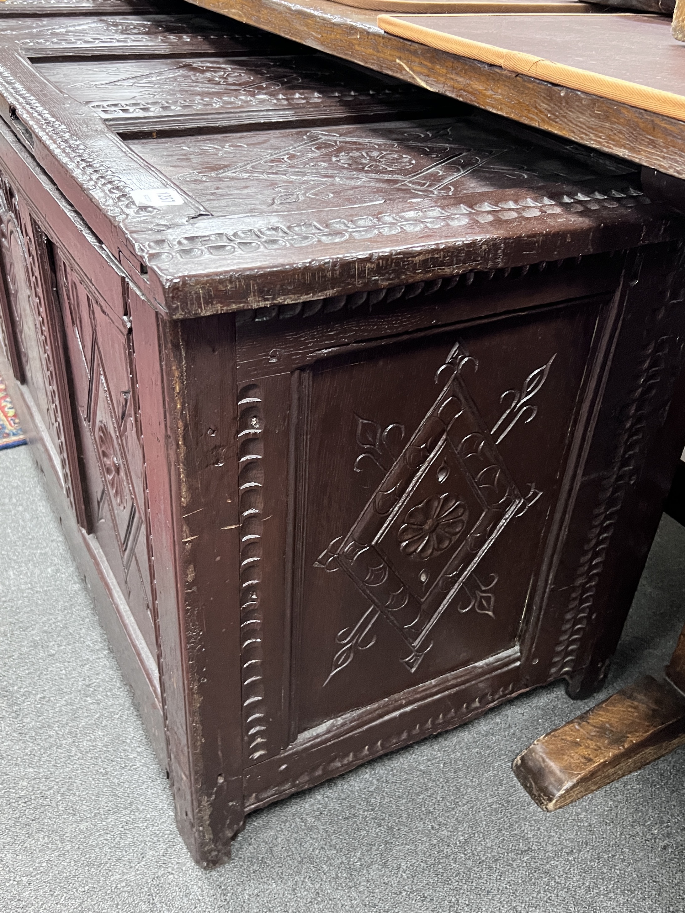 A 17th century later carved oak coffer, width 132cm